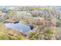 Aerial view of 22 acres property with a house, pool, and pond at 100 Steffey Ln, Taylorsville, NC 28681