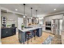 Modern kitchen with granite island, stainless steel appliances, and ample cabinet space at 2824 Huckleberry Hill Dr, Fort Mill, SC 29715