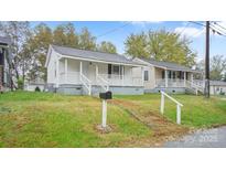 Charming home featuring a quaint front porch and well-maintained lawn at 408 E Washington Ave, Bessemer City, NC 28016