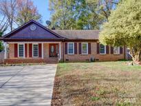 Brick ranch house with a large front yard and driveway at 4706 Calico Ct, Charlotte, NC 28212