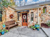 Stone house exterior with a welcoming front porch and landscaping at 501 W Maryland Ave, Bessemer City, NC 28016