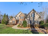 Two story home with brick and stucco exterior and landscaping at 5752 Natoma Rd, Lake Wylie, SC 29710
