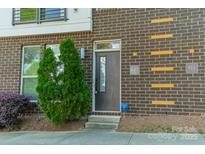 Charming brick townhome with a private front entrance and a well-maintained landscaped garden at 947 Warren Burgess Ln, Charlotte, NC 28205