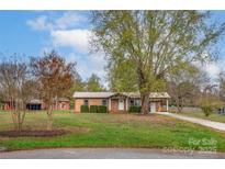 Ranch house with a large yard and driveway at 130 Island Park Ln, Statesville, NC 28625