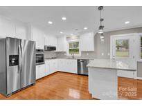 Updated kitchen features stainless steel appliances and granite countertops at 130 Island Park Ln, Statesville, NC 28625