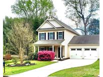 Charming two-story home featuring a well-manicured lawn and a two car garage, perfect for any Gathering at 13112 Appolinaire Dr, Davidson, NC 28036