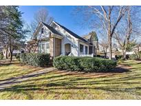 Brick ranch home with a white porch and landscaped yard at 20109 Norman Colony Rd, Cornelius, NC 28031
