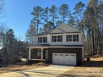Two-story home with brick and white siding, a large garage, and a front porch at 403 Imperial Way # 24, Albemarle, NC 28001