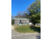 Charming one story home featuring a cozy porch with colorful decorations and a well-maintained front yard at 941 10Th St # 3, Lancaster, SC 29720