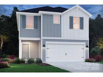 Two-story house with gray and white siding, two-car garage, and landscaping at 216 Alden Ct, Shelby, NC 28152