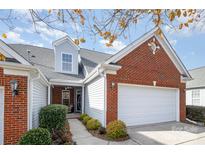 Charming brick and vinyl home featuring an attached garage and well-manicured landscaping at 284 Garnet Ct, Fort Mill, SC 29708