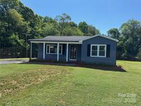 Charming single-story home features a covered porch, fresh landscaping, and a well-manicured lawn at 3596 Bethany Church Rd, Claremont, NC 28610