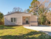 Charming single-story home with a manicured lawn and inviting entrance at 1209 Moretz Ave, Charlotte, NC 28206