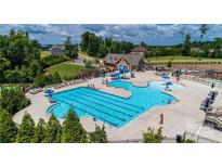 Aerial view of the community pool area showcasing the pool, clubhouse, and lounge seating at 14027 Grand Traverse Dr, Charlotte, NC 28278