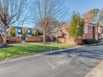 Brick front exterior of townhome with landscaping and street view at 884 Park Slope Dr, Charlotte, NC 28209