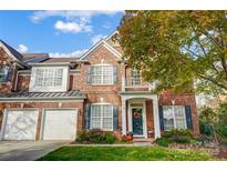 Two story brick home with a charming front entrance and landscaping at 7943 Oratorio Pl, Charlotte, NC 28270