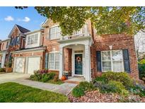 Brick front home with shutters, landscaping, and a welcoming porch at 7943 Oratorio Pl, Charlotte, NC 28270