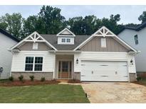Charming single-Gathering home with a 2-car garage, inviting entrance, and manicured lawn at 9130 Dulwich Dr # Ken0079, Charlotte, NC 28215
