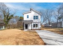 Charming two-story home with vertical siding and a concrete driveway at 1097 Georgetown Rd, Lincolnton, NC 28092