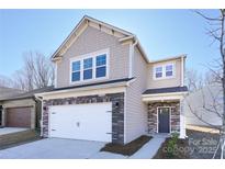 Two-story house with stone accents and a two-car garage at 2033 White Cypress Ct # Kh06, Charlotte, NC 28216