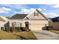 Charming single-Gathering home with manicured lawn and attached two-car garage in a suburban neighborhood at 3006 Cricket Ln, Lancaster, SC 29720