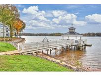 Picturesque waterfront property featuring a gazebo-covered dock extending into a serene lake at 907 Southwest Dr, Davidson, NC 28036