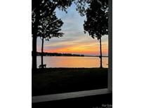 Stunning sunset view over serene lake from lakeside property at 907 Southwest Dr, Davidson, NC 28036