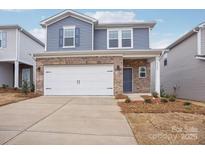 Two-story house with gray siding, brick accents, and a two-car garage at 1345 31St Ne St, Conover, NC 28613