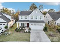 Charming two-story home featuring a spacious two-car garage and a covered front porch at 1356 Augustus Beamon Dr, Indian Trail, NC 28079