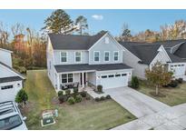 Two-story house with gray siding, red door, and a two-car garage at 1356 Augustus Beamon Dr, Indian Trail, NC 28079