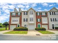 Brick townhome with 2-car garage and landscaping at 140 Rock Ridge Ln, Mount Holly, NC 28120