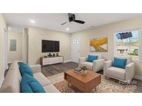 Bright living room with hardwood floors, comfy seating, and a modern coffee table at 2409 Crescent Ln, Gastonia, NC 28052