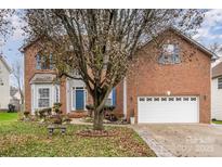 Brick two-story house with a two-car garage and landscaping at 4813 Chesney Nw St, Concord, NC 28027