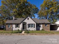 Charming bungalow exterior with stone accents and a well-maintained lawn at 406 Harris Ln, Monroe, NC 28112