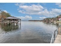 Calm lakefront view with boat lift and dock at 110 Fern Haven Ln, Mooresville, NC 28117
