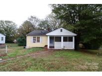 Charming single-story home with a covered porch and well-maintained lawn surrounded by mature trees at 1840 Findlay St, Gastonia, NC 28052