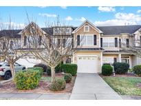 Charming townhome featuring a two-car garage, inviting curb appeal, and neutral siding at 310 Rose Garden Ct, Rock Hill, SC 29732