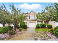 Charming two-story home with a well-maintained yard and beautiful flowering trees at 310 Rose Garden Ct, Rock Hill, SC 29732