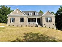 Charming brick home with a welcoming front porch and manicured lawn at 3850 Willow Grove Ln # 24, Concord, NC 28025