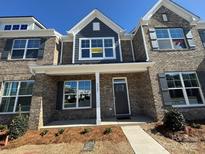 Charming townhome with brick facade, covered entrance, and well-maintained landscaping at 5527 Stafford Rd # 34, Charlotte, NC 28215