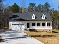 Charming single-story home with white siding, dormer windows, front porch, and an attached two-car garage at 1647 Davis Farm Rd, York, SC 29745