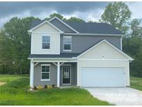 Charming two-story home with a gray and white exterior, showcasing a welcoming front entrance and an attached garage at 282 New Salem Rd, Statesville, NC 28625