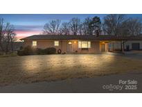 Brick ranch house with attached carport and spacious yard at 2351 Hudspeth Rd, Catawba, NC 28609