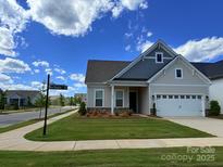 Charming single-Gathering home features a well-manicured lawn, neutral siding, and a two-car garage at 405 Northgate Blvd, Indian Trail, NC 28079