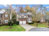 Charming two-story brick home with a well-manicured lawn and two-car garage at 8619 Delamere Ln, Charlotte, NC 28269