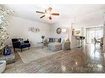 Spacious living room featuring a neutral color palette, fireplace, and ample natural light at 11001 Carmel Crossing Rd, Charlotte, NC 28226