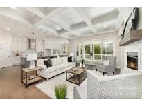 Spacious living room with coffered ceilings, fireplace, and sliding glass doors leading to the outdoors at 267 Triple Ponds Ct # 11, Clover, SC 29710