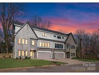 Three-unit modern townhome building with gray and white exterior at 2911 Hilliard Dr, Charlotte, NC 28205