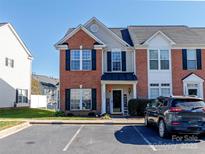 Inviting townhome with brick facade, black shutters, and a welcoming front porch in a well-maintained community at 3000 Misty Harbor Cir # F, Cramerton, NC 28032