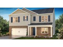Two-story house with a brick and siding exterior, two-car garage, and landscaping at 3861 Cullen Meadows Dr, Davidson, NC 28036